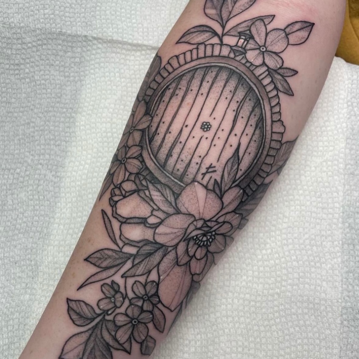 Harp and flowers dotwork tattoo on the forearm by Christopher Layman