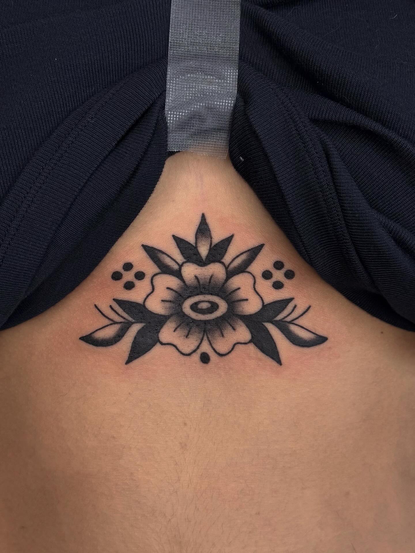 Flower black and grey tattoo on the ribs by Bridgette Carberry