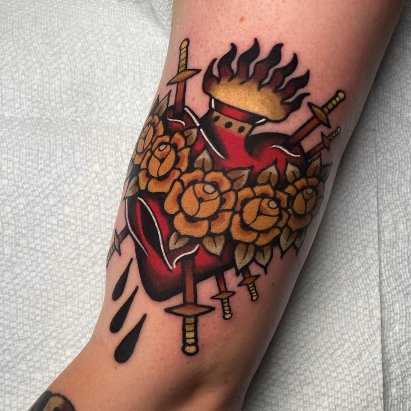 Heart with crown and swords American traditional tattoo on the forearm by Matthew Limbers⚜️