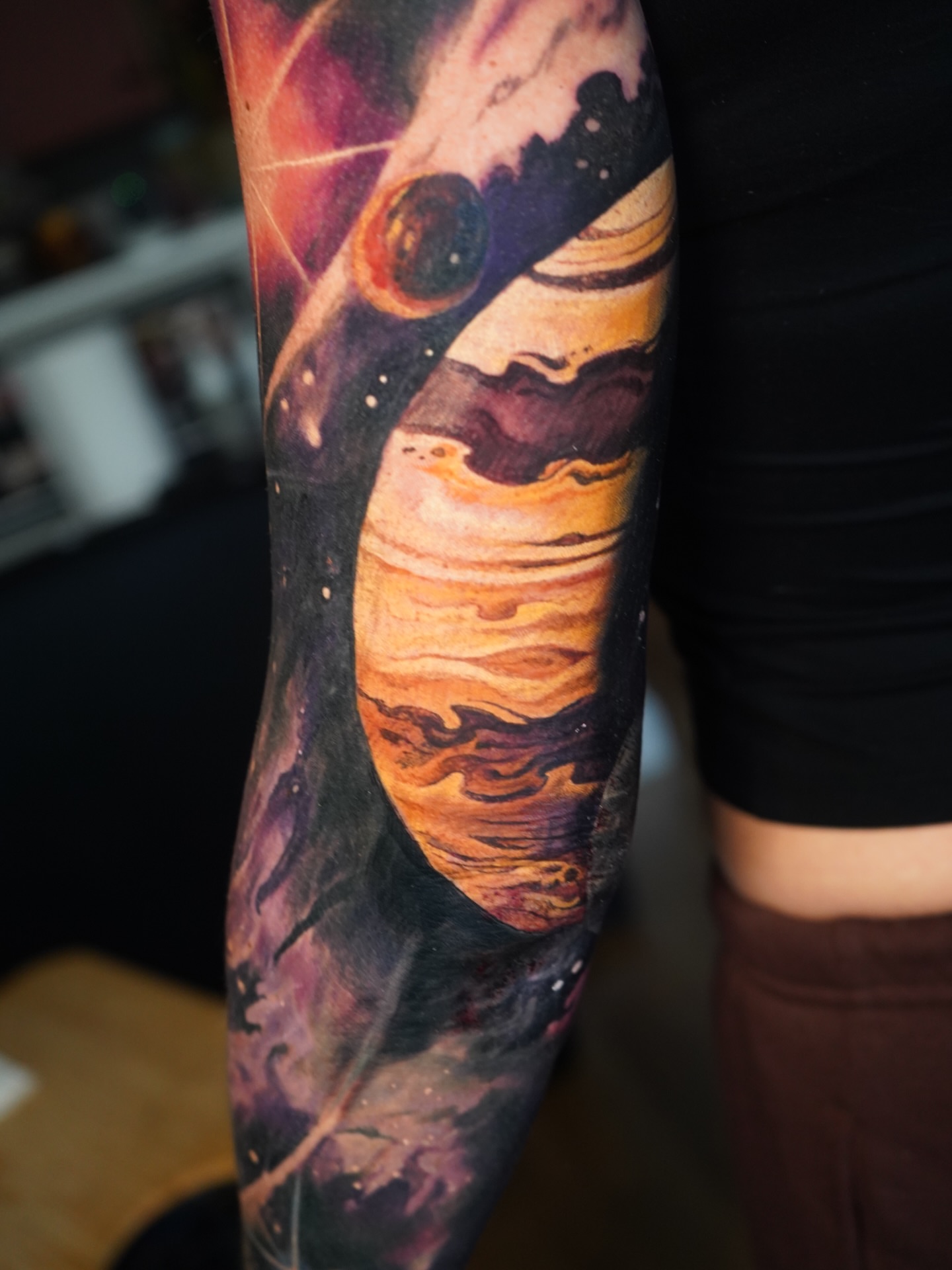 Space scene realism tattoo on the forearm by Darl Gnau