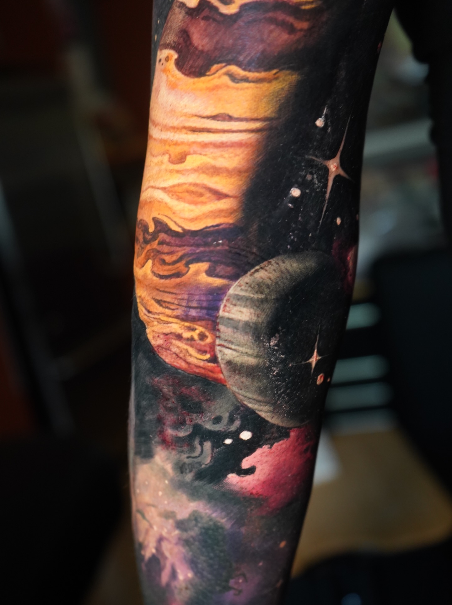 Space scene realism tattoo on the forearm by Darl Gnau