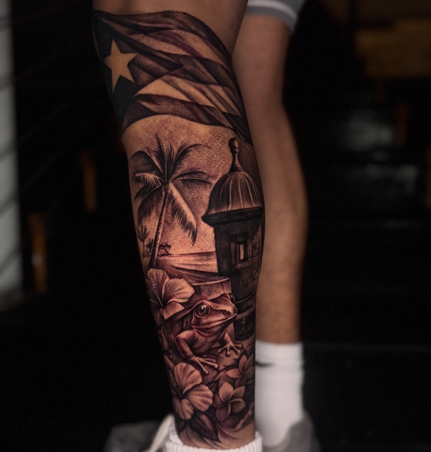 Tropical landscape realism tattoo on the calf by tombstone