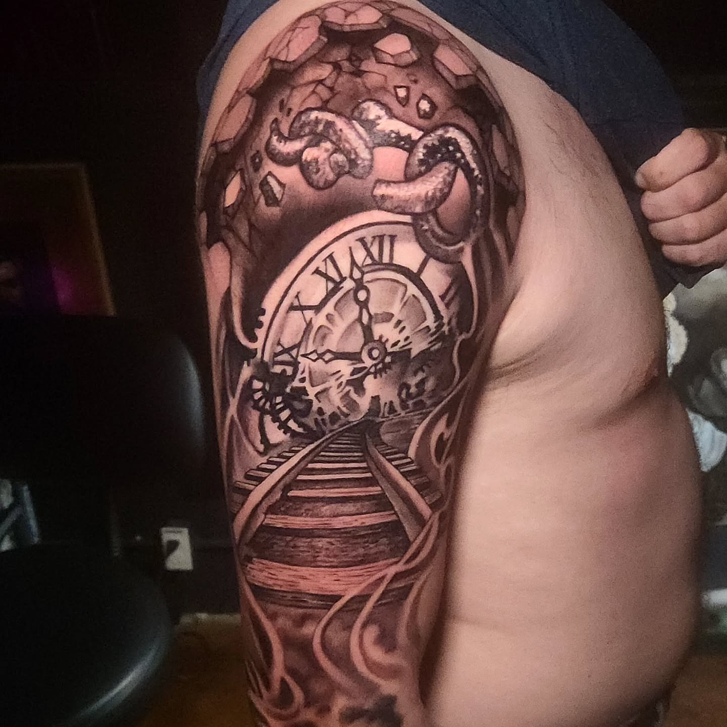 Clock and train tracks realism tattoo on the upper arm by Jack Jr Mora