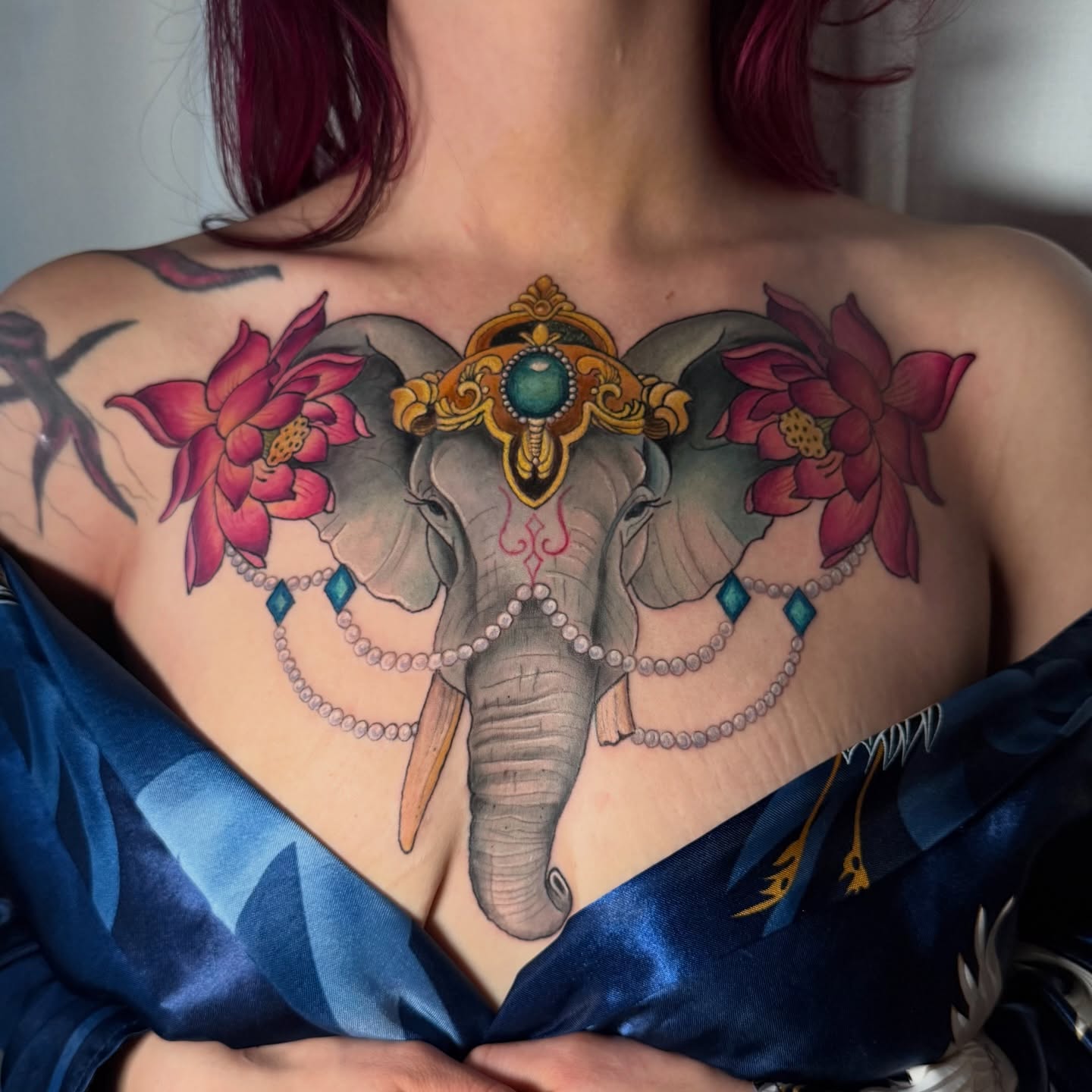 Elephant with floral decorations new school tattoo on the chest by Sharon Healy