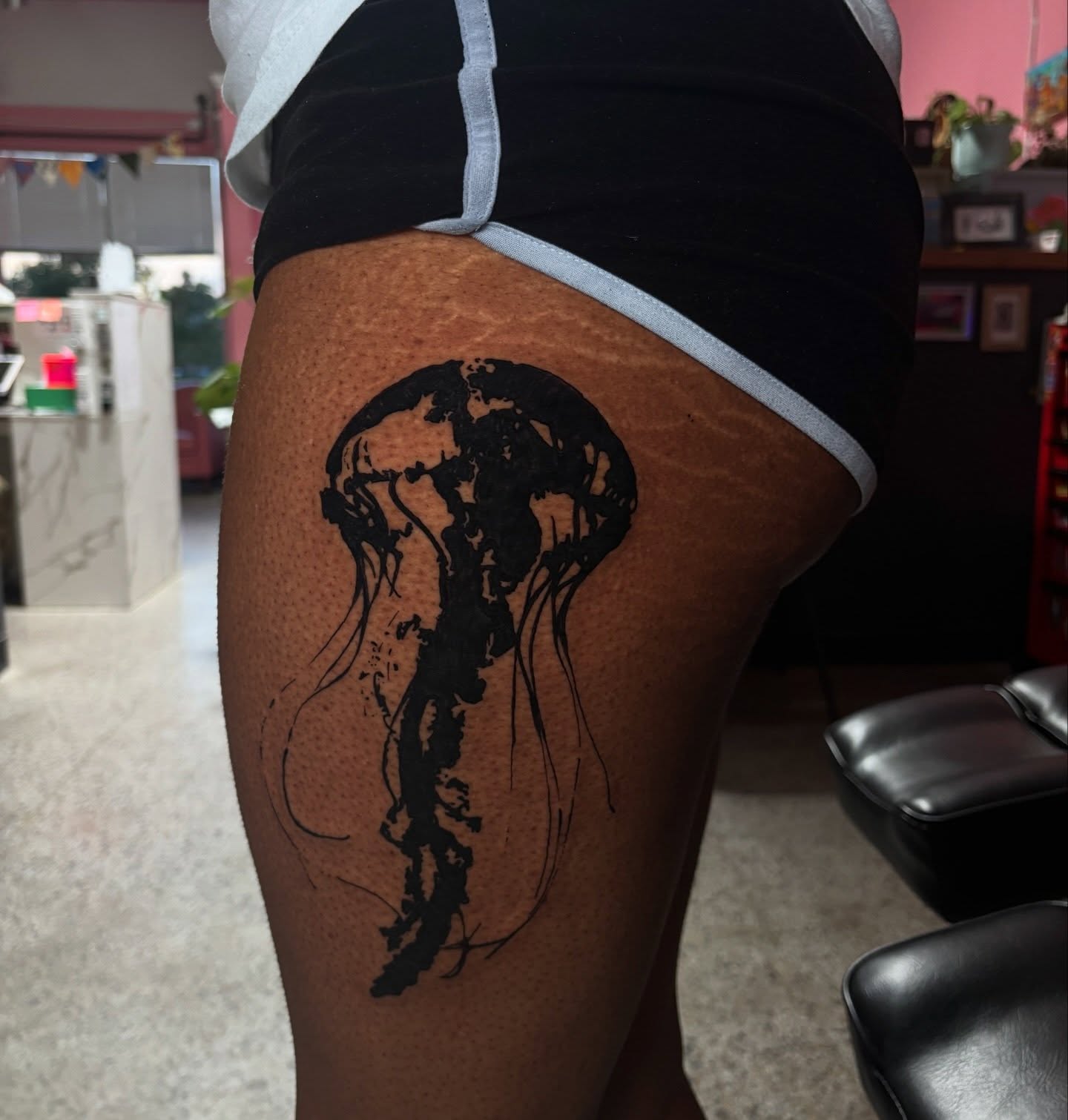 Jellyfish black and grey tattoo on the thigh by neal