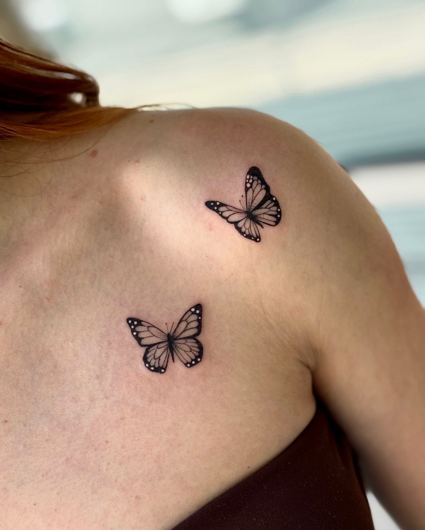Butterflies black and grey tattoo on the shoulder by Emily Velletta, Huntersville, North Carolina