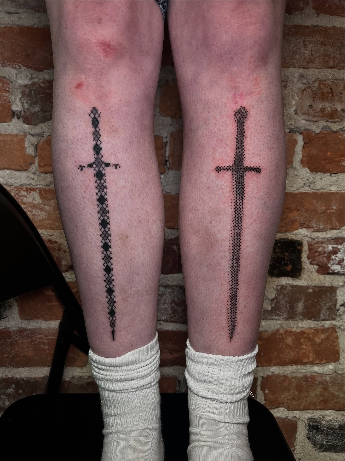 Sword dotwork tattoo on the calf by Uncomfy Comfort Tattoos LLC