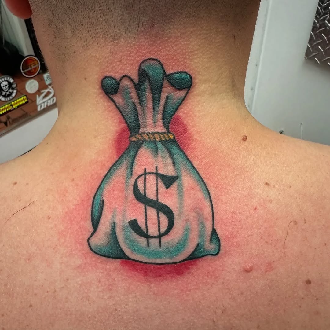 Money bag with dollar sign tattoo on the back by Greyson Heidenreich