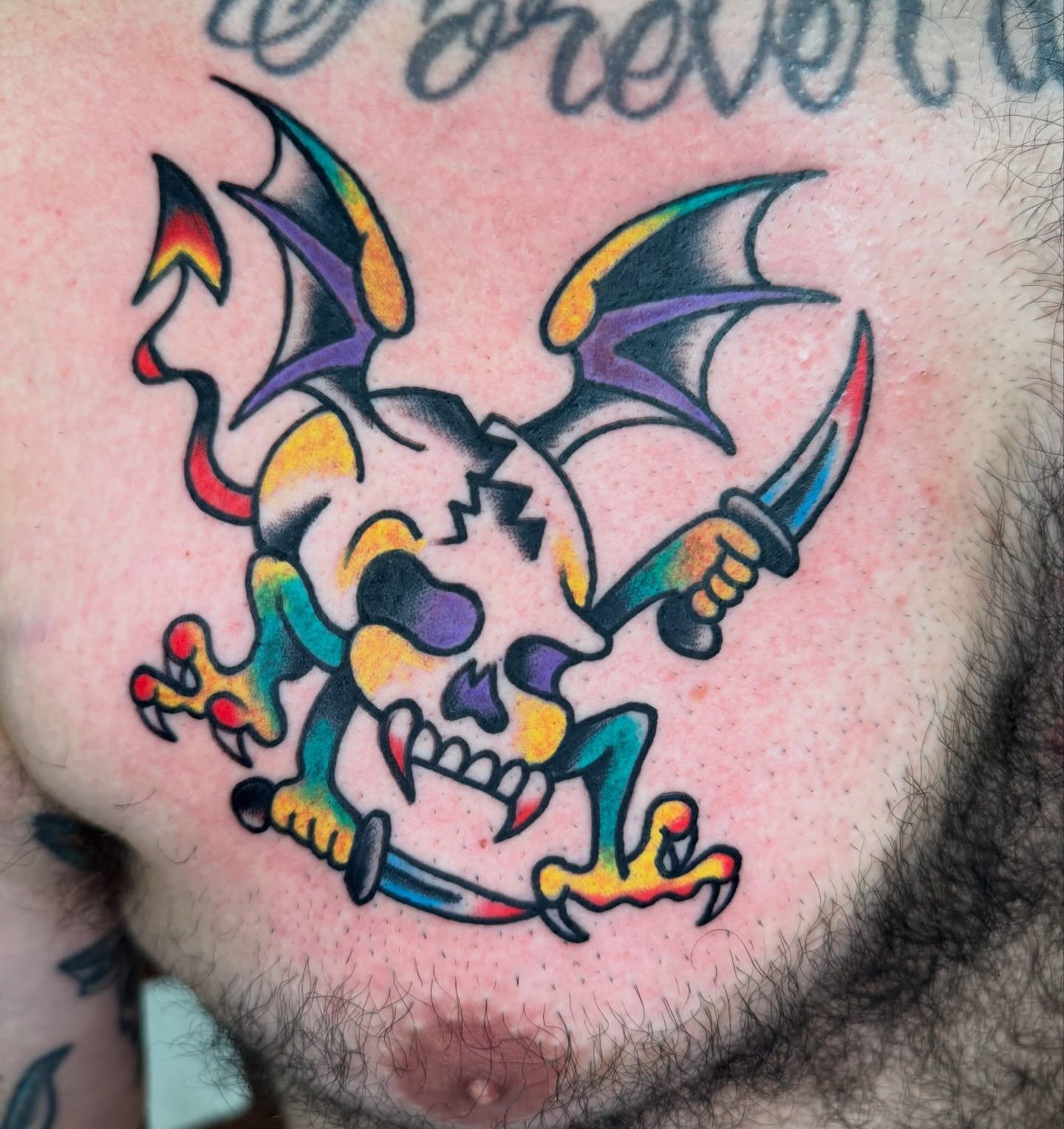 Skull with bat wings American traditional tattoo on the chest by Kenny Kastro