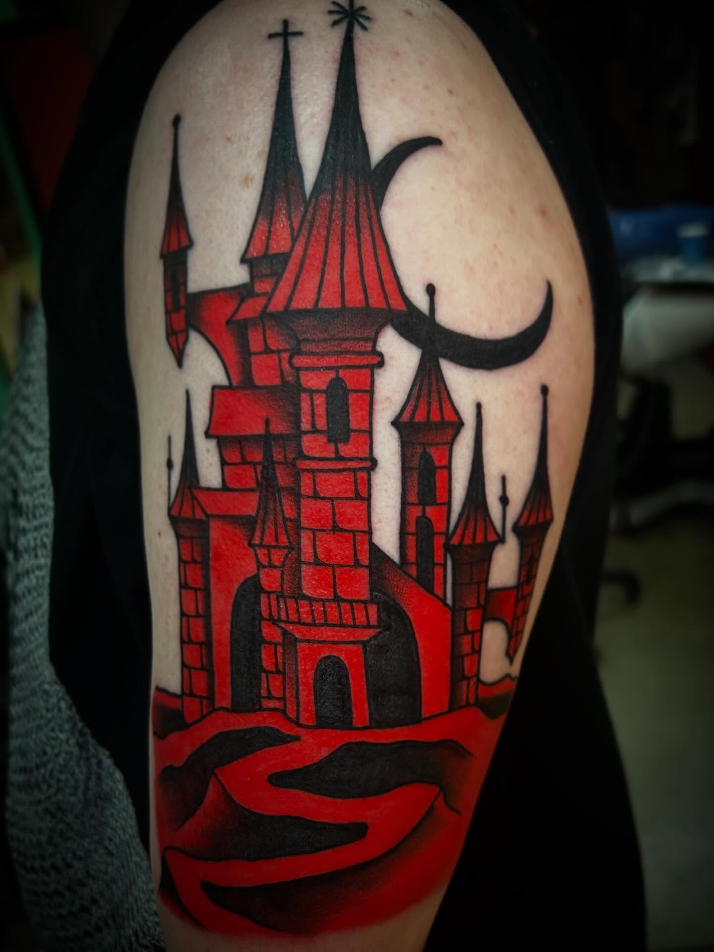 Castle American traditional tattoo on the upper arm by Katie Dexter, Des Moines, Iowa