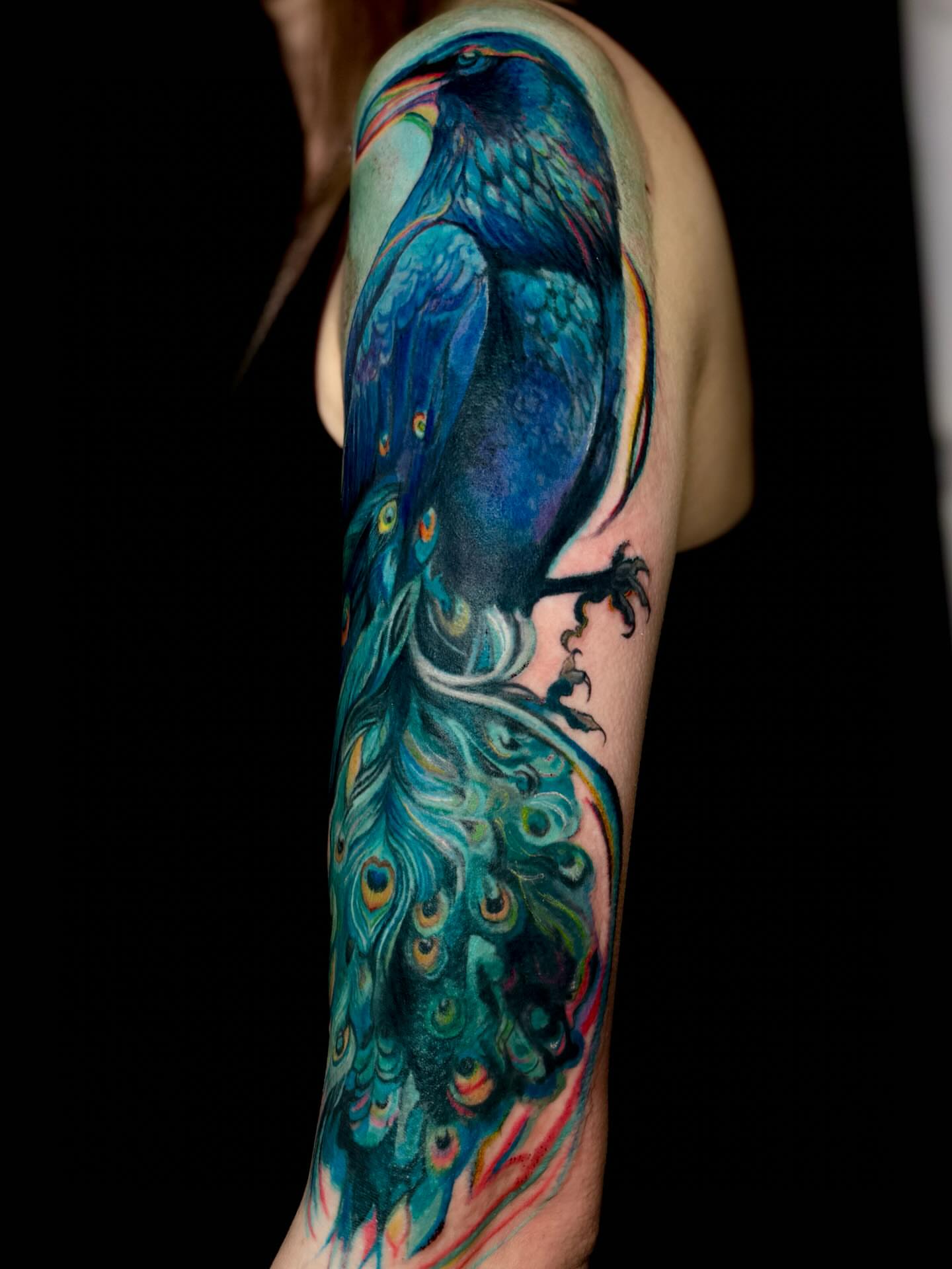 Peacock and crow realism tattoo on the forearm by Nyahzul - Glitch Tattoo Artist NYC
