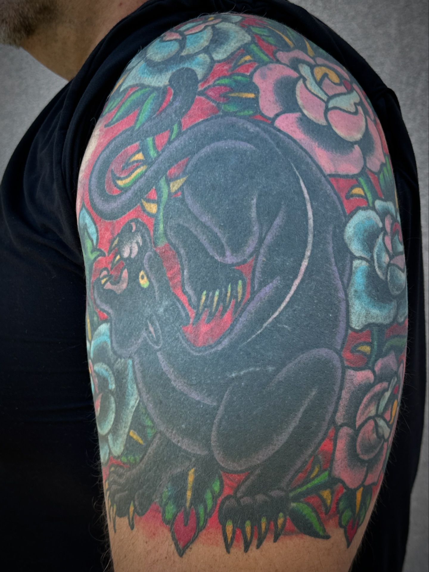Panther and flowers American traditional tattoo on the shoulder by Chris Blanchard