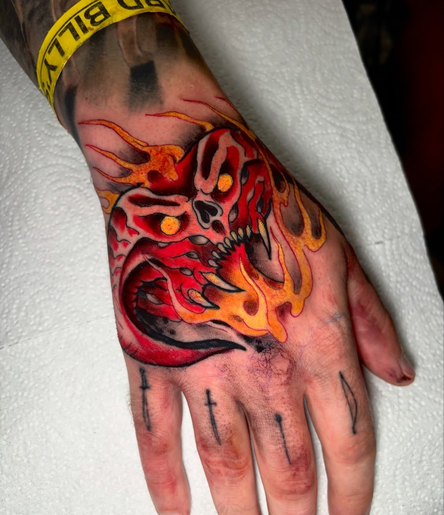 Flaming skull dark realism tattoo on the hand by Matt Stolzenburg