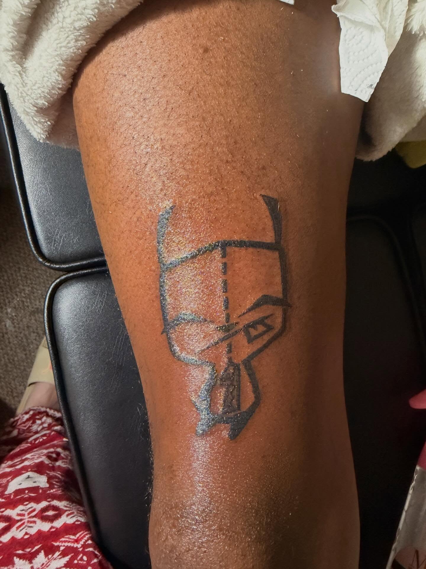 Batman logo black and grey tattoo on the thigh by @bloodline__legacy