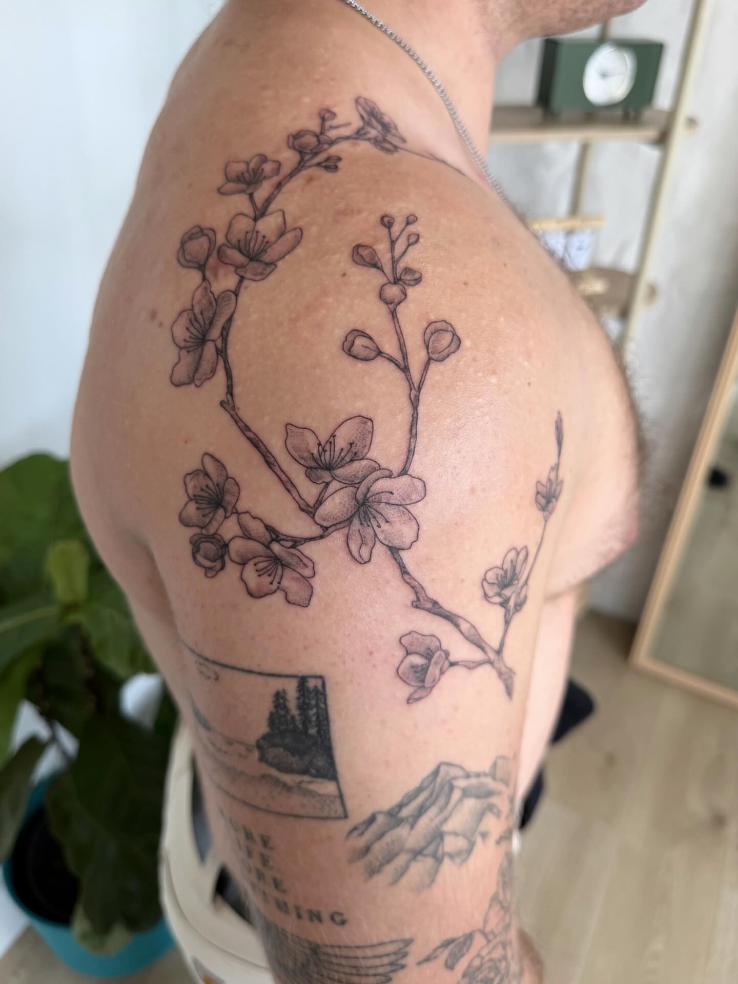 Cherry blossom branch black and grey tattoo on the shoulder by Priscila - HAWAII TATTOO