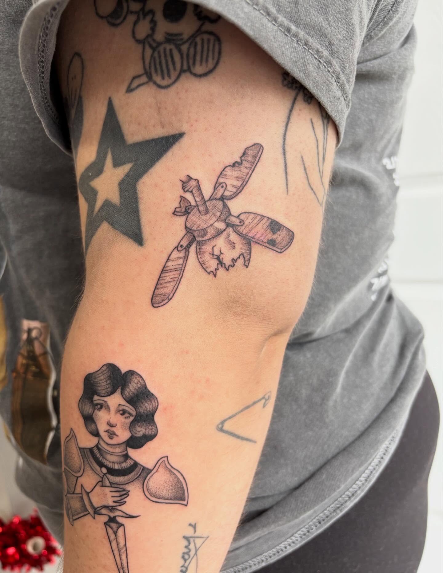 Insect and woman black and grey tattoo on the forearm by Hailey Nicole