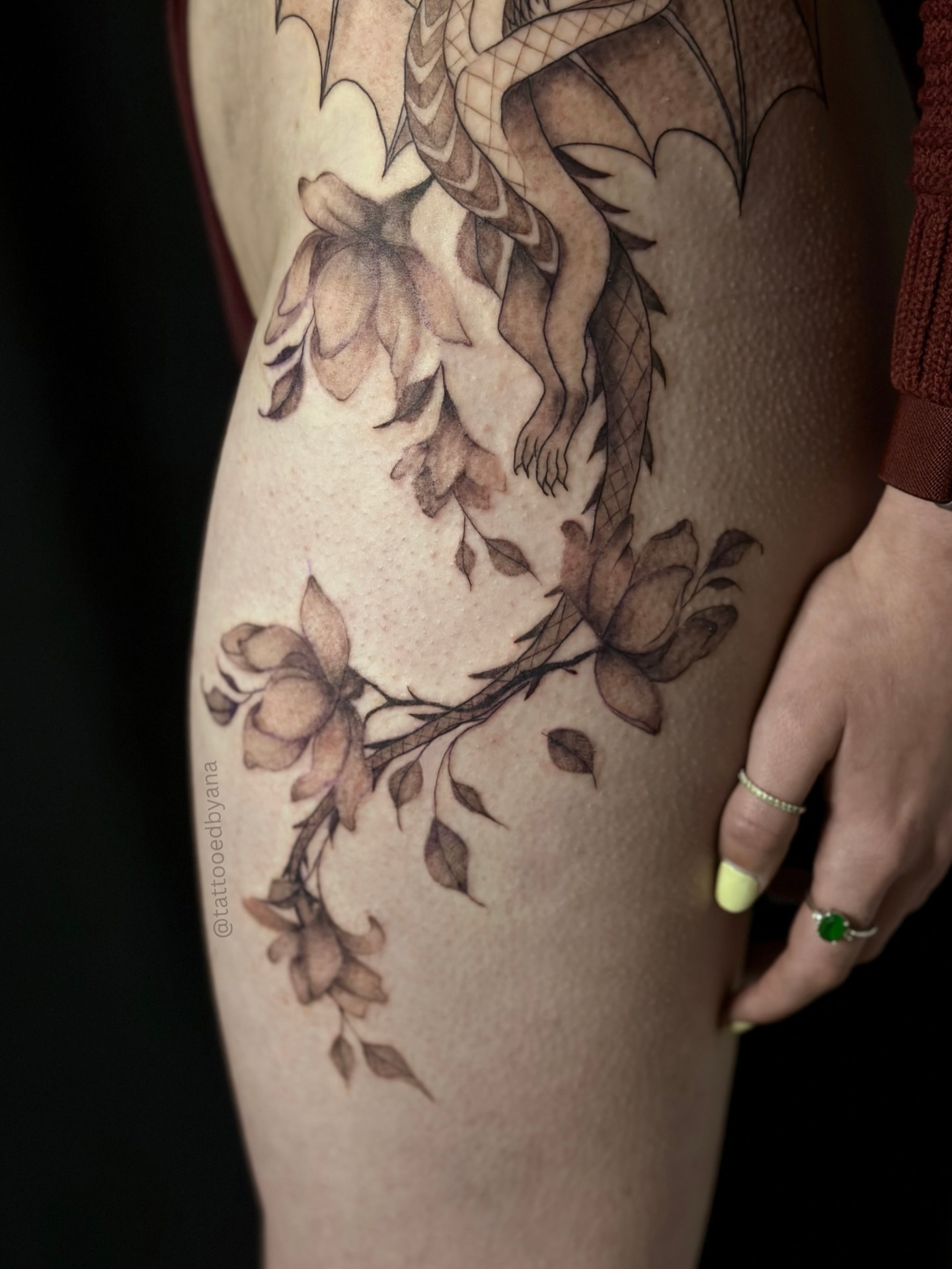Dragon and flowers black and grey tattoo on the thigh by Tattoo artist Denver