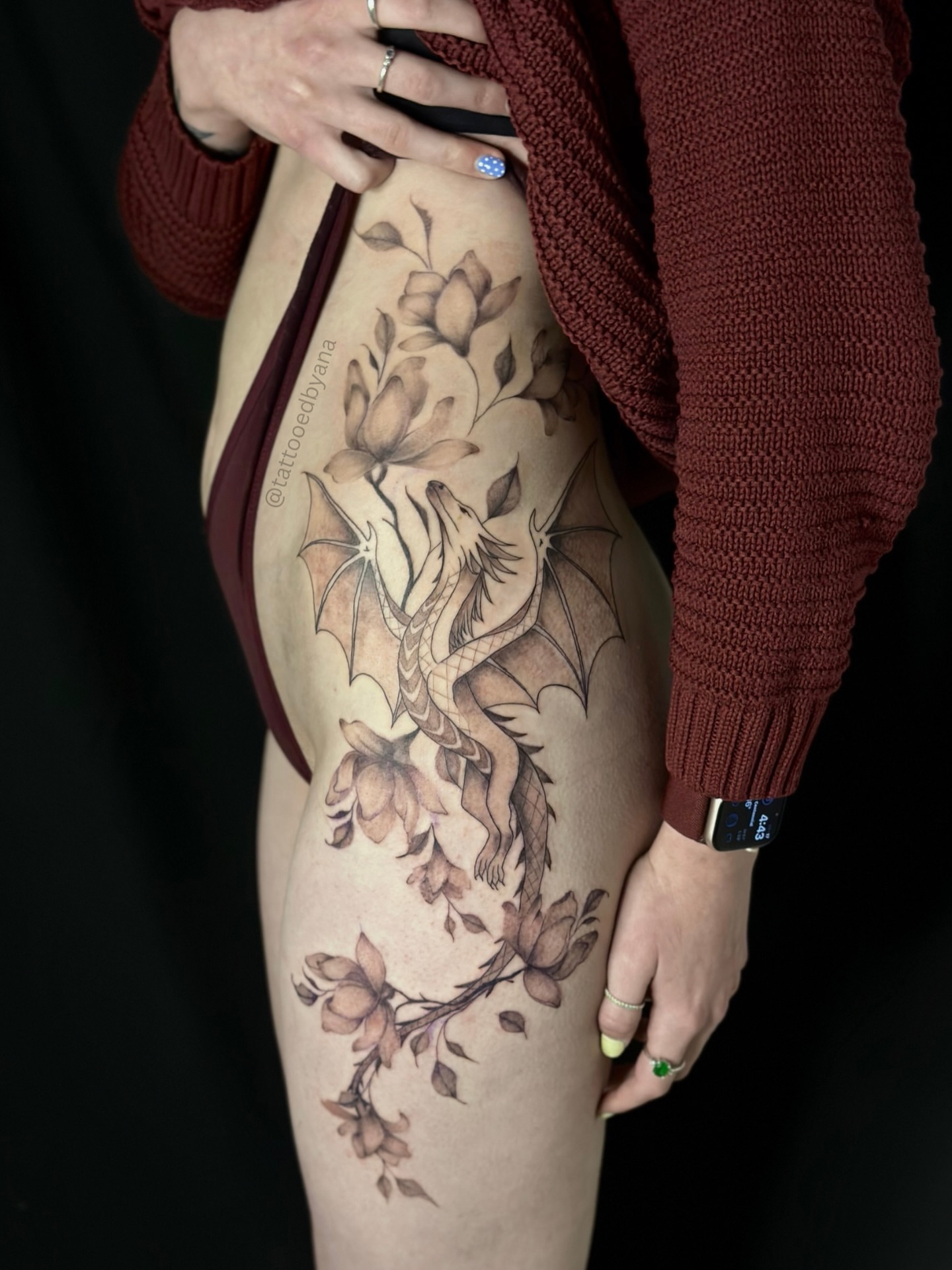 Dragon and flowers realism tattoo on the thigh by Tattoo artist Denver