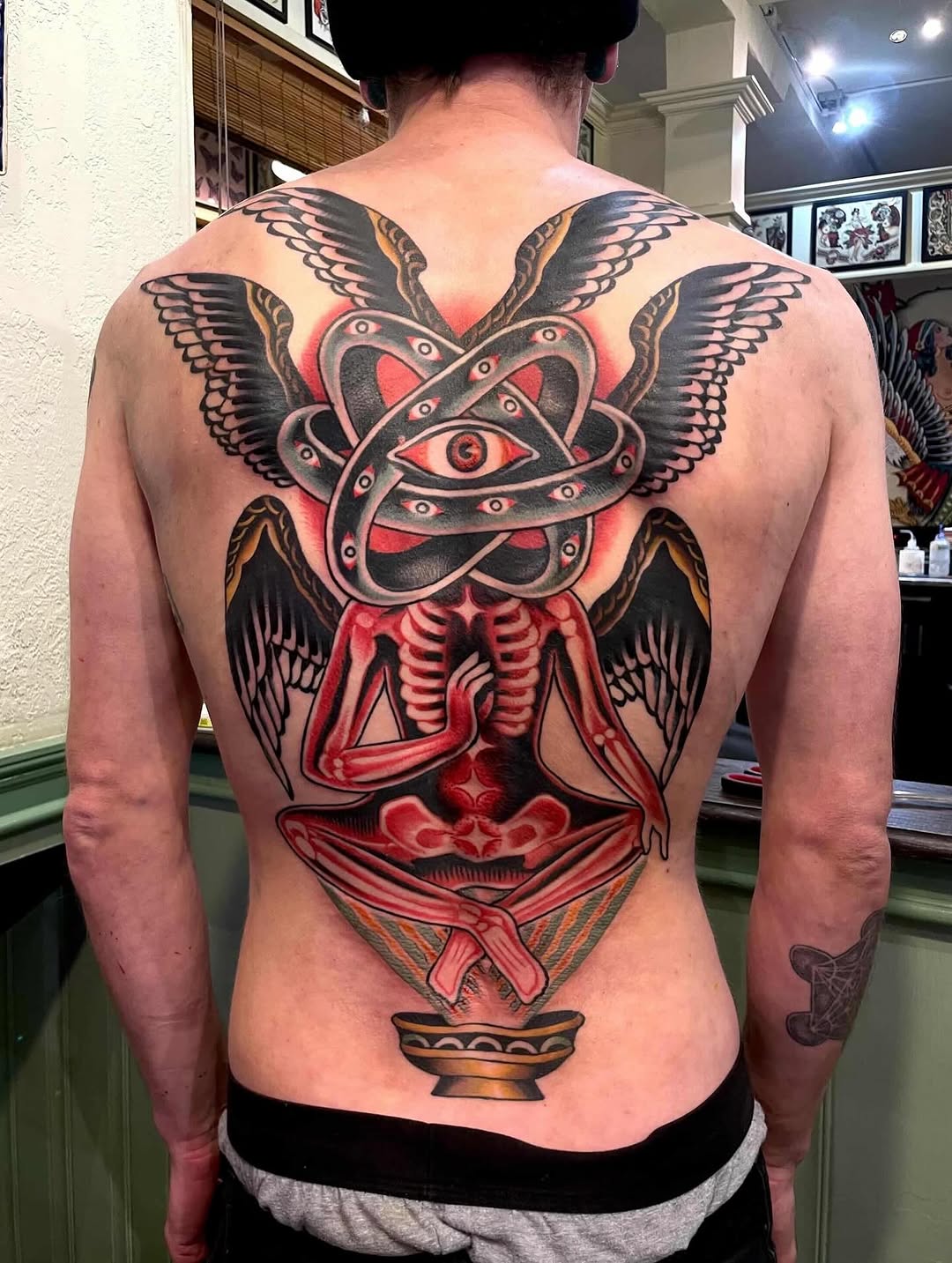 Biblical creature with skeleton American traditional tattoo on the back by Pavel