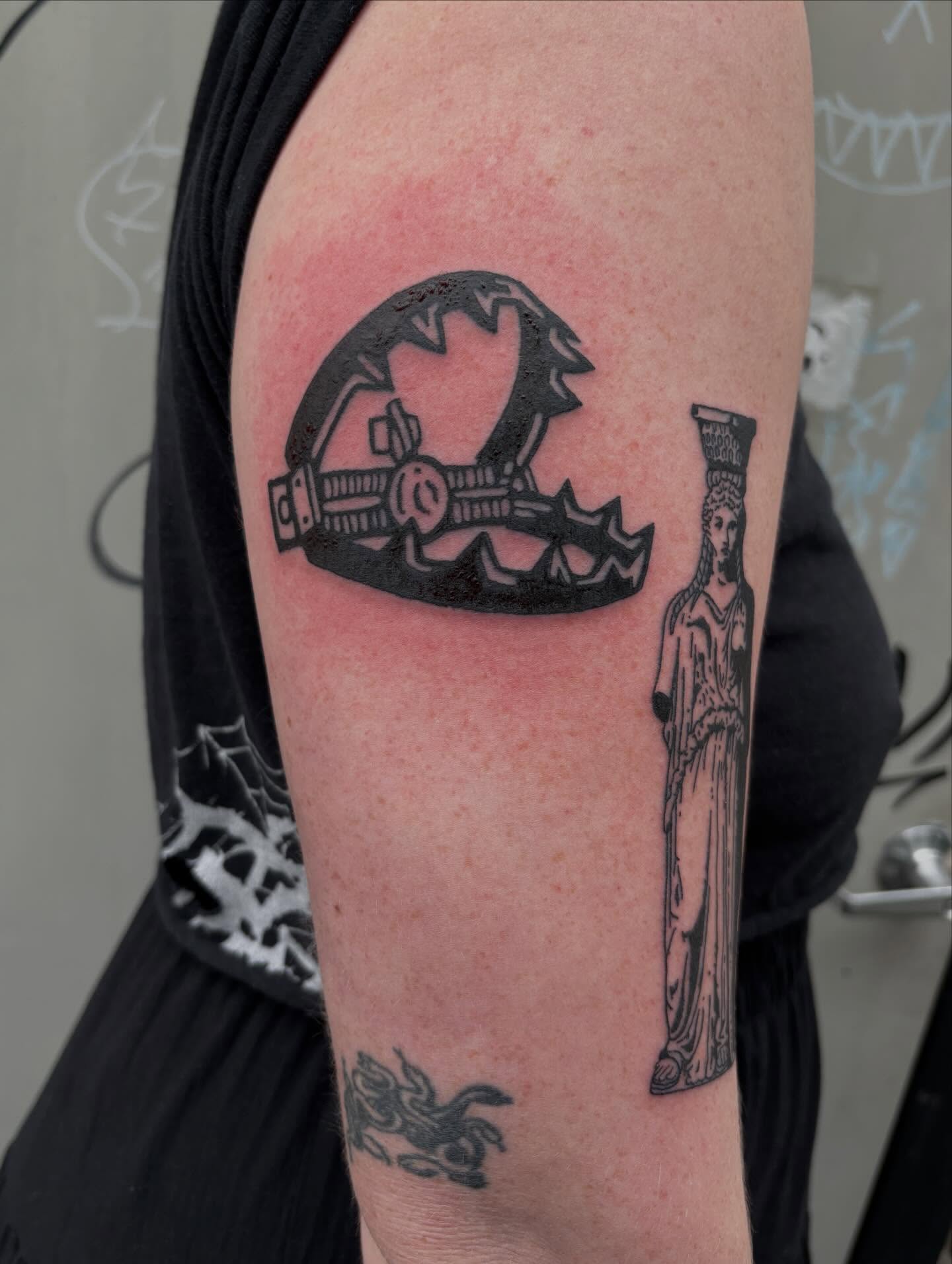 Statue and saw black and grey tattoo on the forearm by Turner