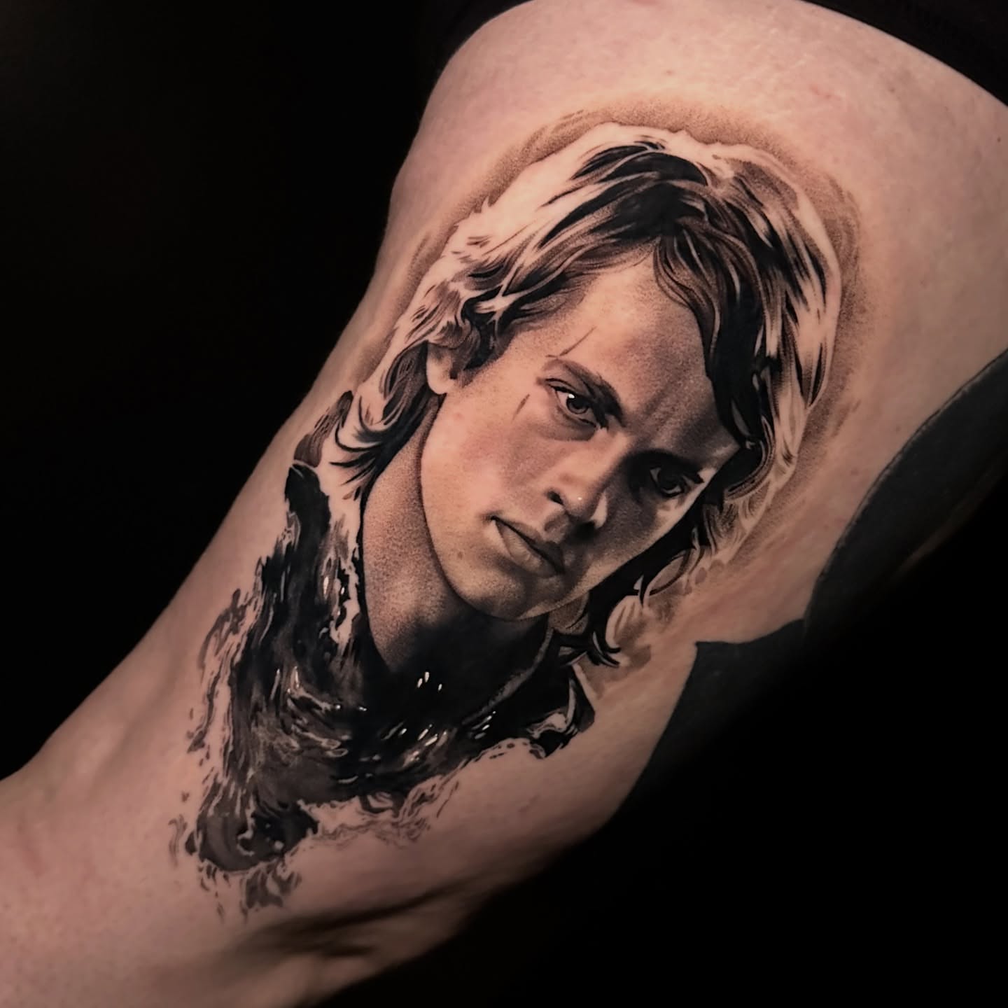 Portrait realism tattoo on the upper arm by Breah Beshore Kirk