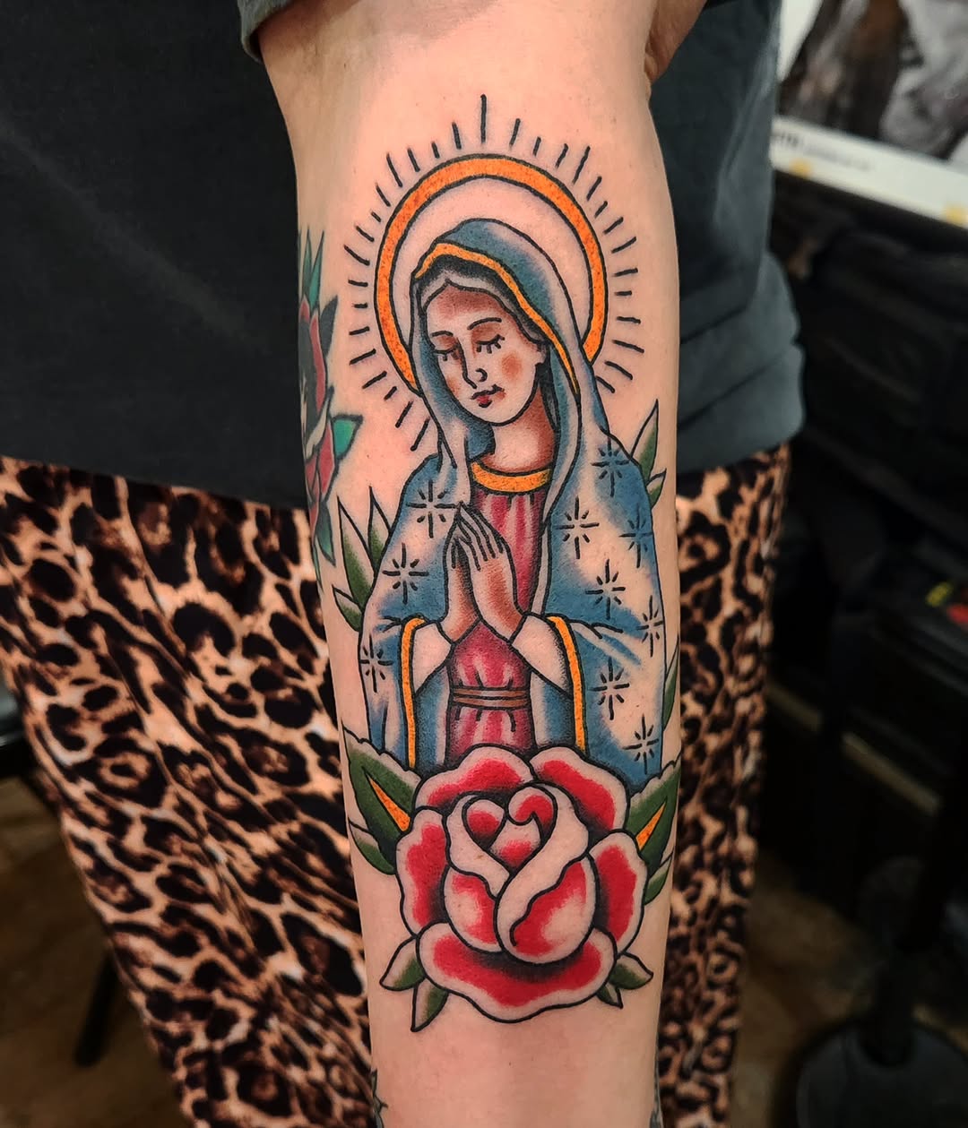 Virgin Mary and rose neo-traditional tattoo on the forearm by Douglas Grady