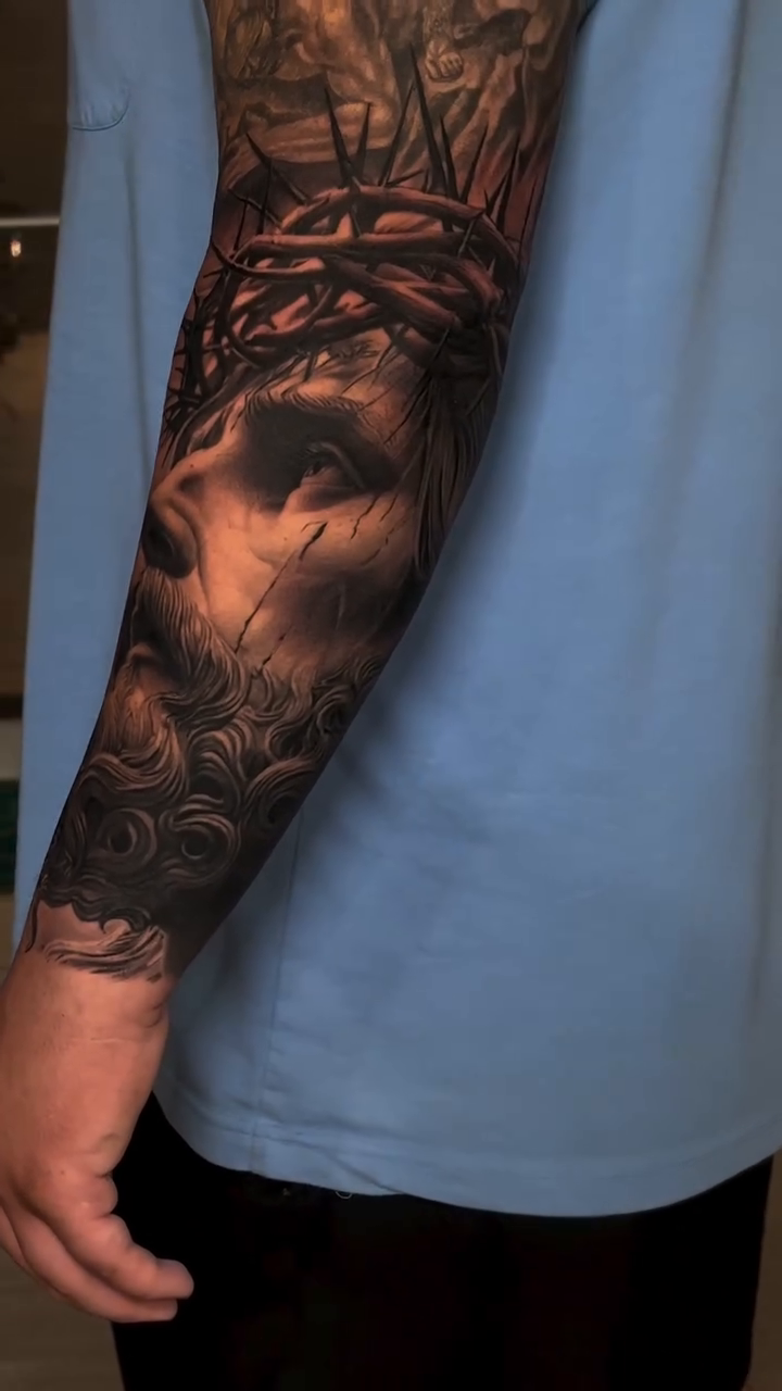 Jesus Christ portrait sleeve Chicano tattoo on the forearm by Guillermo Columbie, Houston, Texas