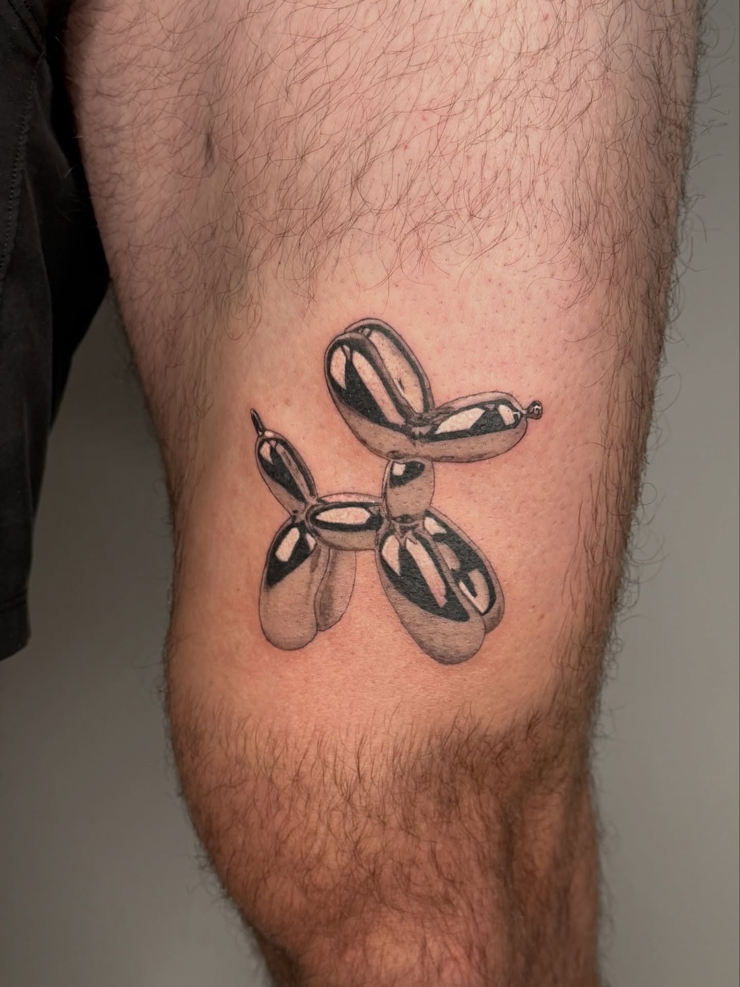Balloon animal black and grey tattoo on the leg by Jerm Lewis