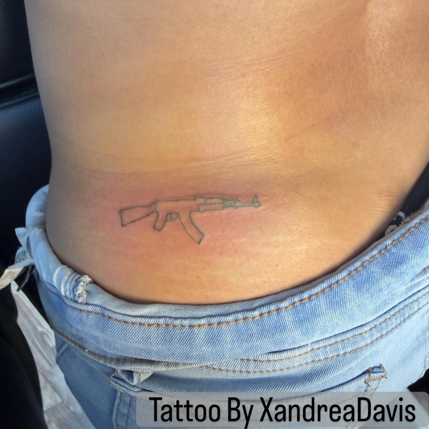 Machine gun black and grey tattoo on the torso by XoXandrea.Ink, Kansas City, Missouri