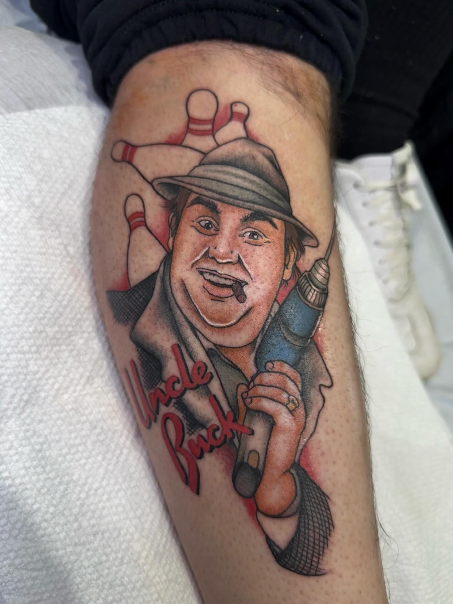 Uncle Buck realism tattoo on the forearm by Mikaila Rose Krauss