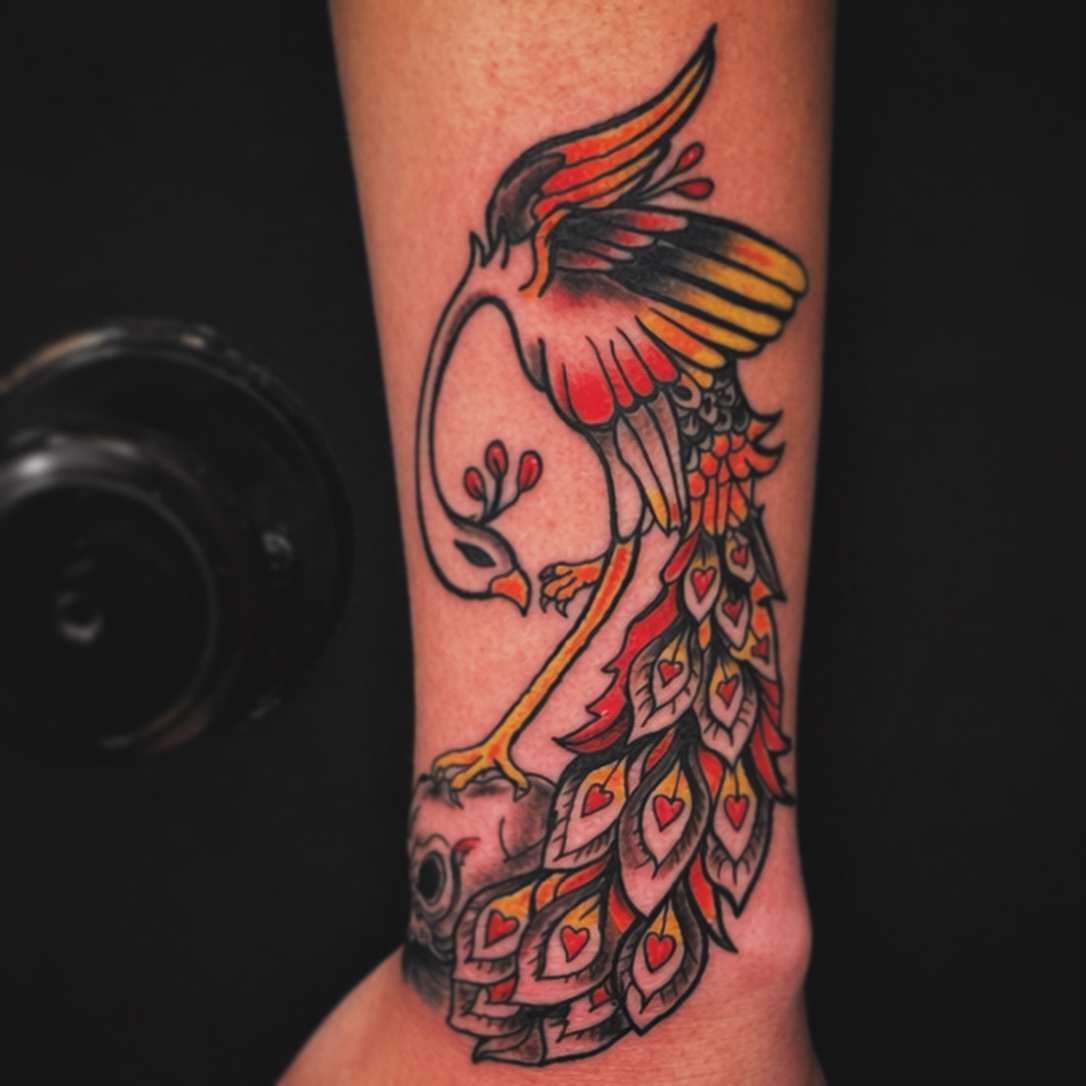 Phoenix American traditional tattoo on the forearm by Evan Intveld