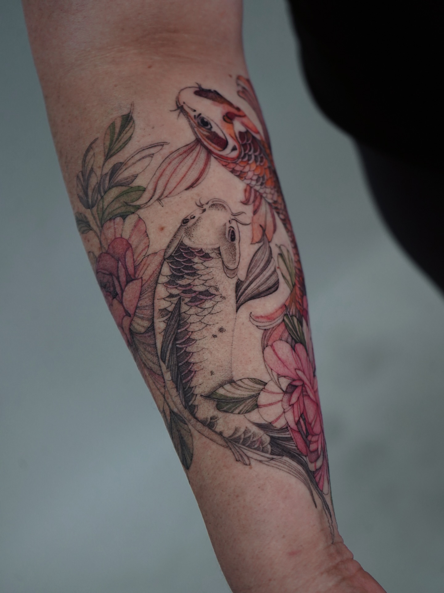 Koi fish and flowers japanese irezumi tattoo on the forearm by Flower Tattoo Sf