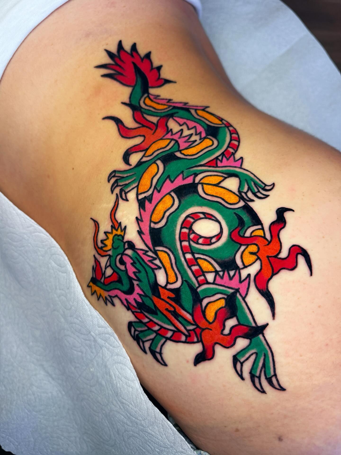 Dragon American traditional tattoo on the thigh by Britt Kuechenmeister, Culver City, California
