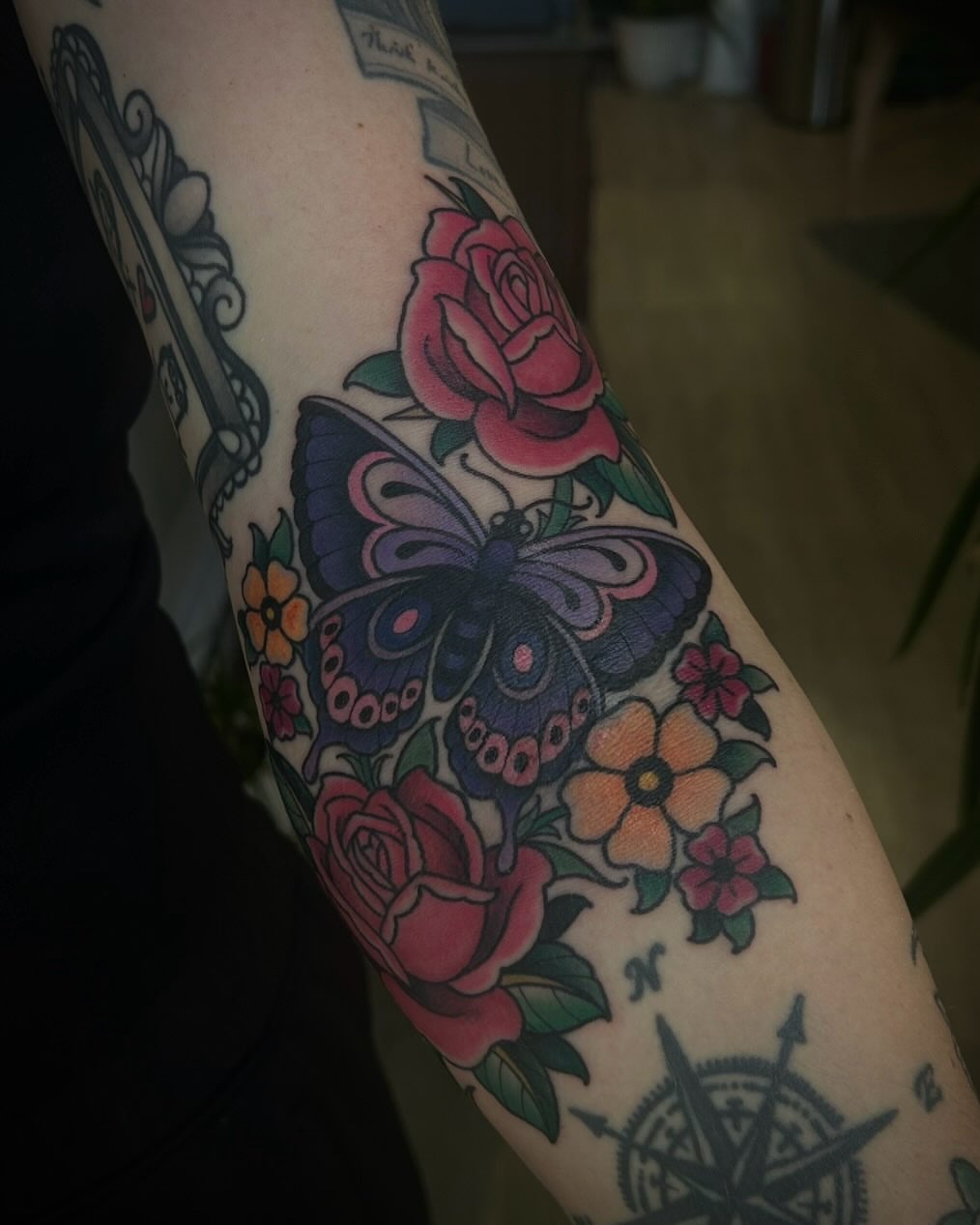 Butterfly and roses American traditional tattoo on the forearm by ꧁𝙺𝚊𝚛𝚒𝚗𝚊꧂, Grinnell, Iowa