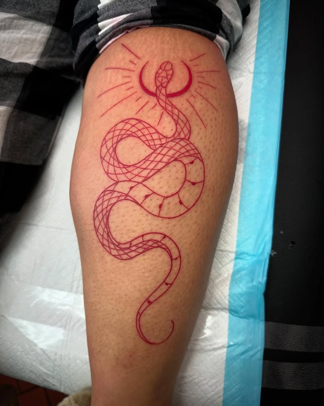 Snake with crescent moon American traditional tattoo on the thigh by Greyson Heidenreich