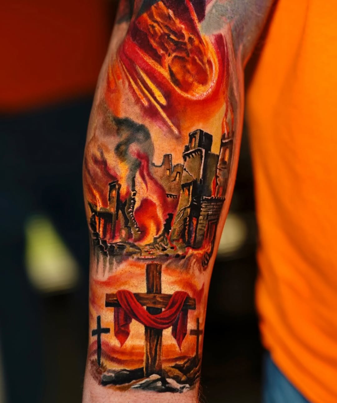 Burning city and crosses realism tattoo on the forearm by David Gordon