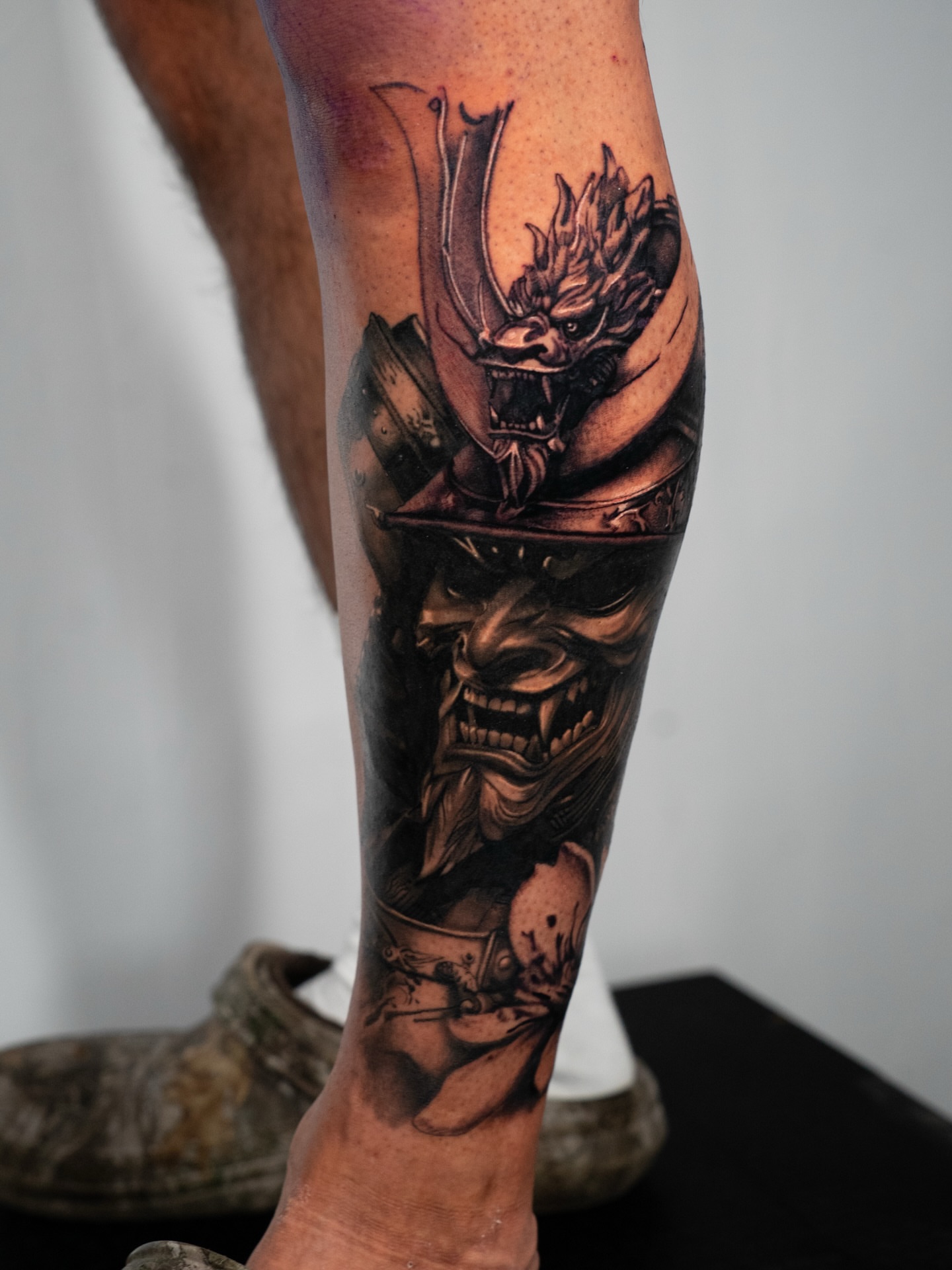 Demon warrior dark realism tattoo on the calf by Nate