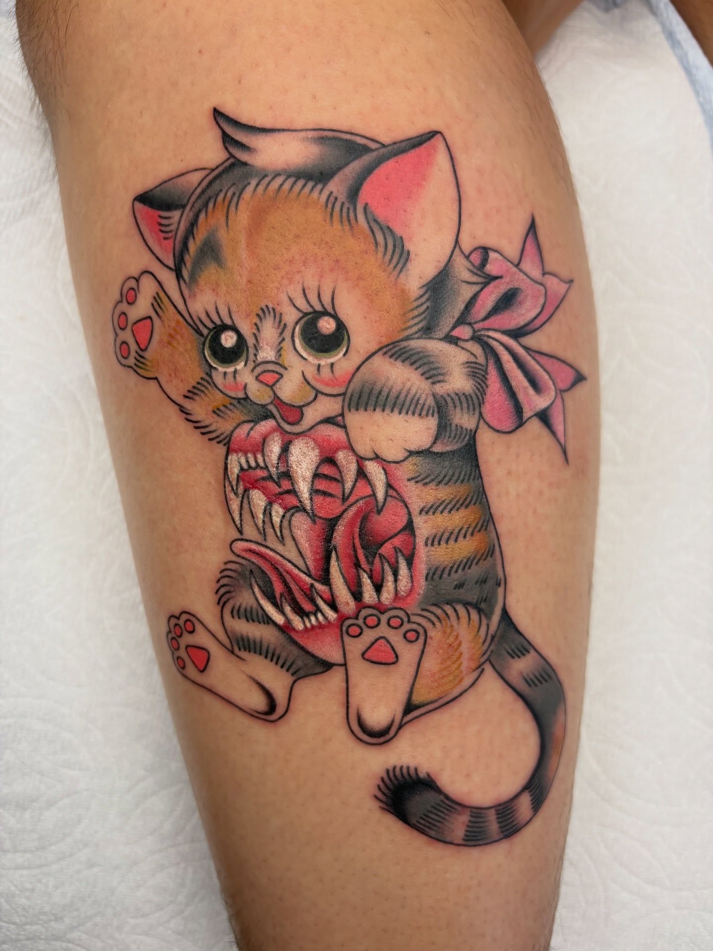 Cat American traditional tattoo on the thigh by Nori