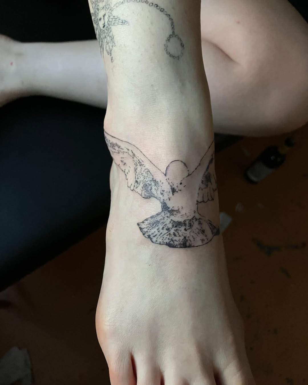 Dove fine line tattoo on the foot by Sashka