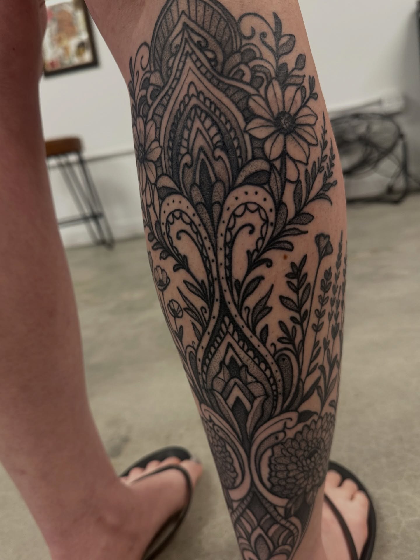 Floral pattern ornamental tattoo on the calf by Christopher Layman