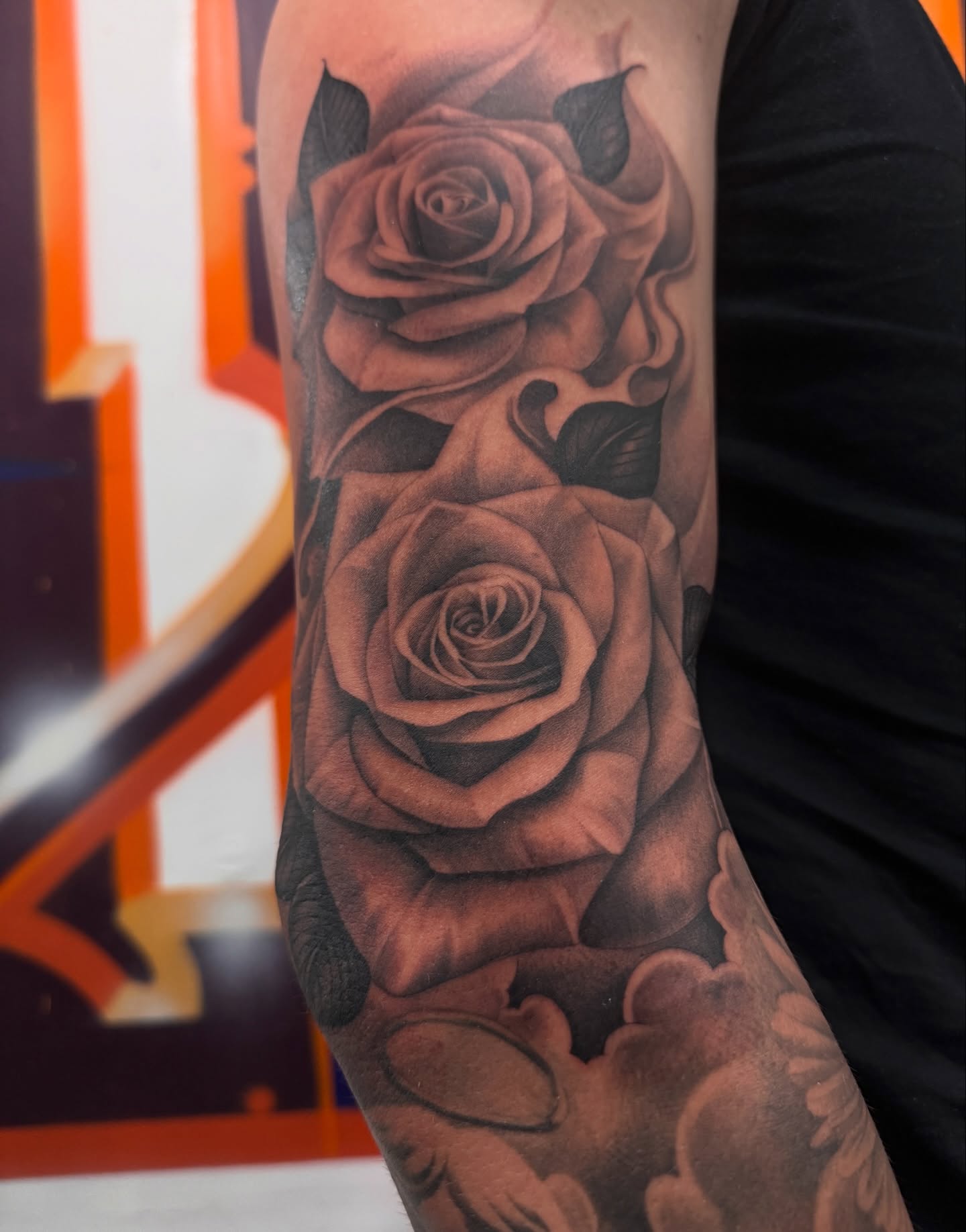 Roses black and grey tattoo on the forearm by tombstone
