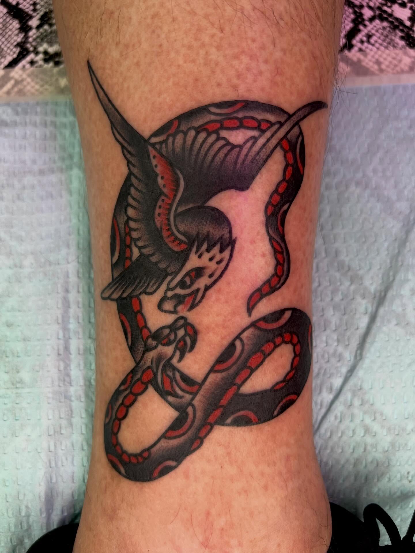 Bird and snake American traditional tattoo on the forearm by Charlie Campanella