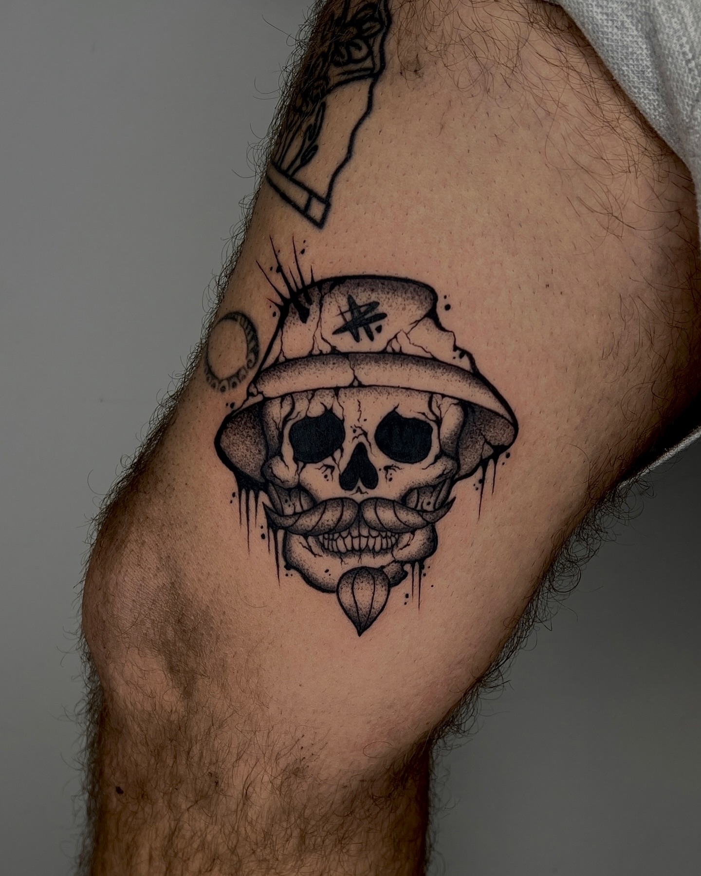 Skull wearing hat dotwork tattoo on the forearm by Rebel milly Tattoo