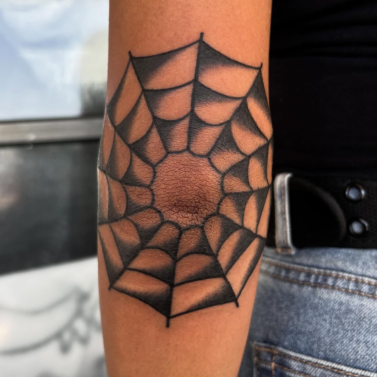 Spider web geometric tattoo on the forearm by Allyson Monique