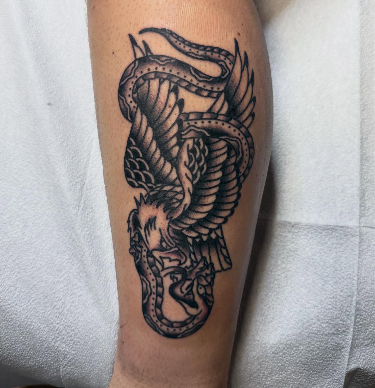 Dragon black and grey tattoo on the forearm by Ryan Moraski, Colorado Springs, Colorado