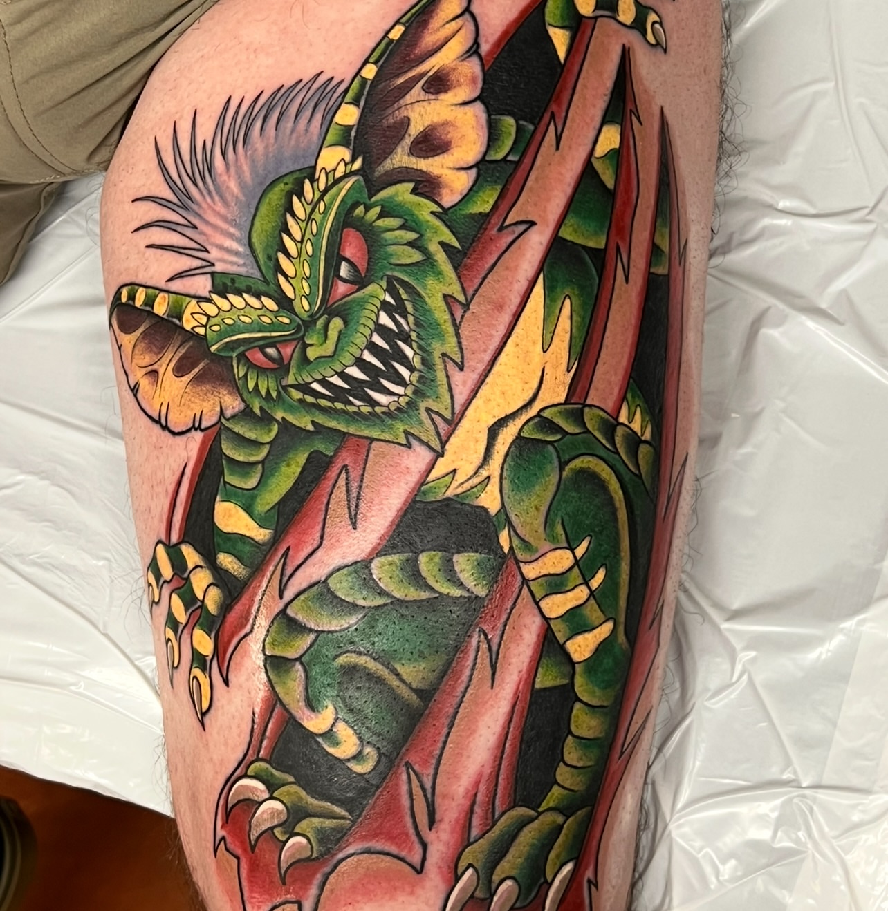 Dragon American traditional tattoo on the thigh by Bobby Tobin