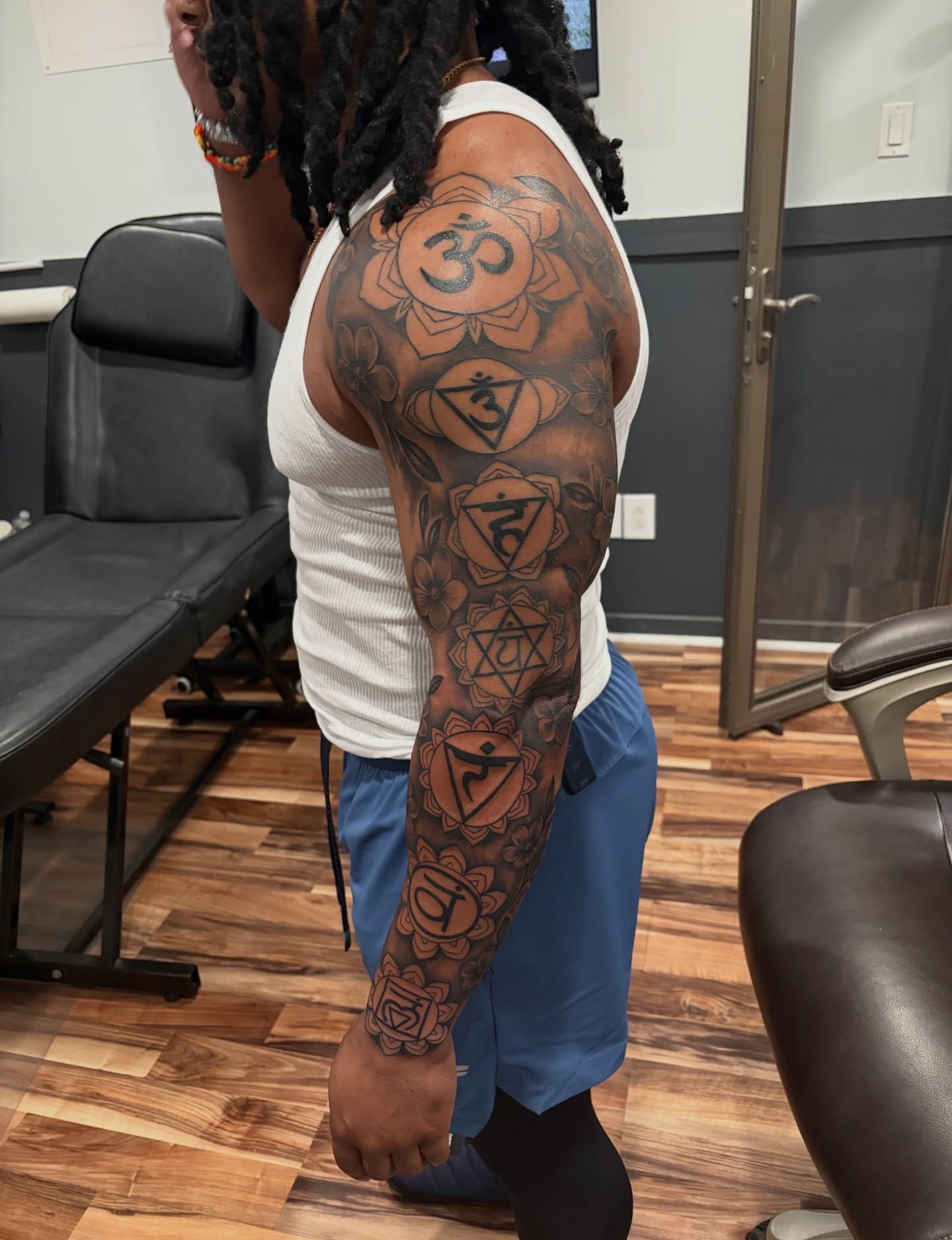 Chakra symbols geometric tattoo on the upper arm by Blake