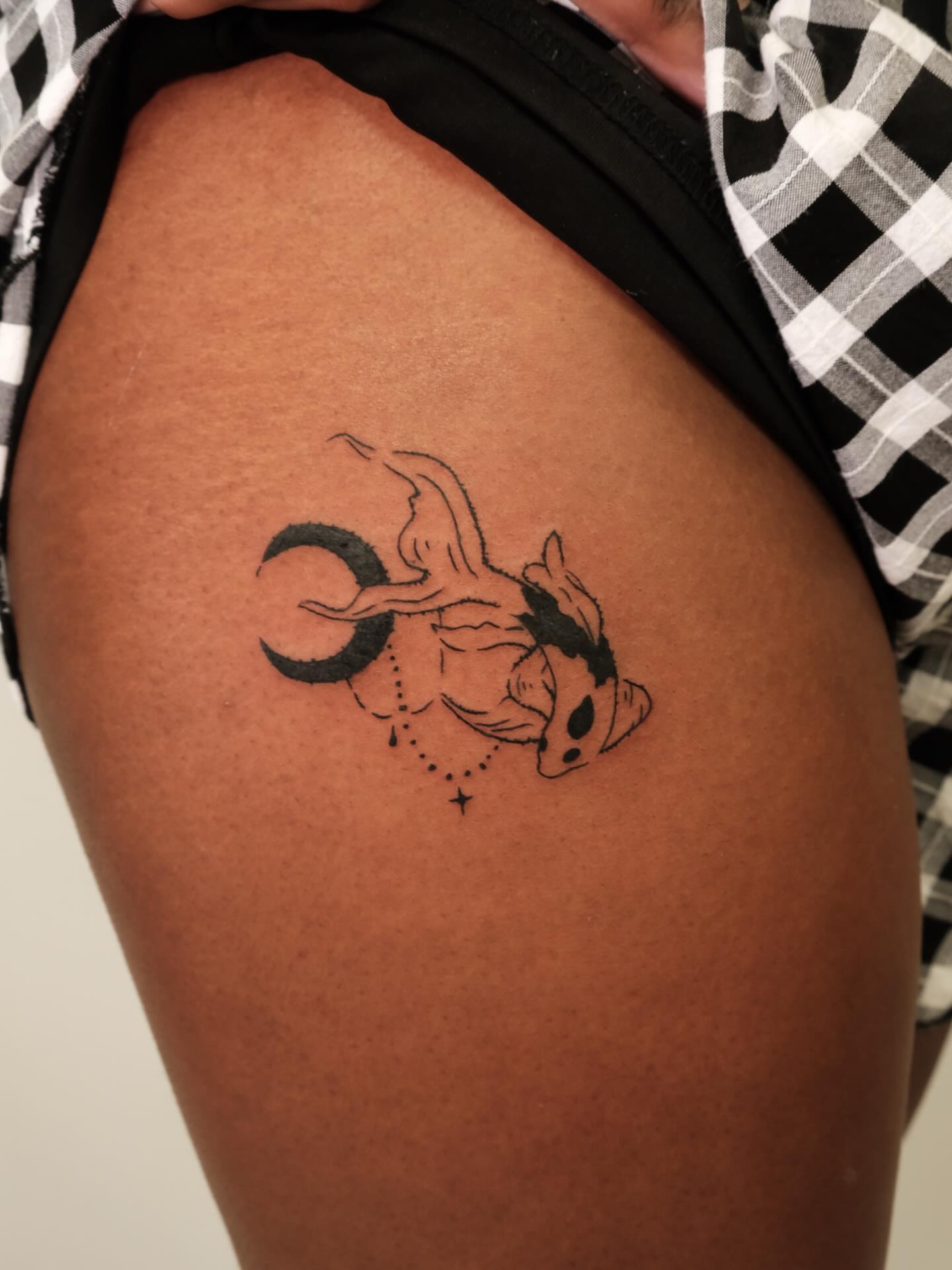 Goldfish and crescent moon dotwork tattoo on the thigh by Elana Hites