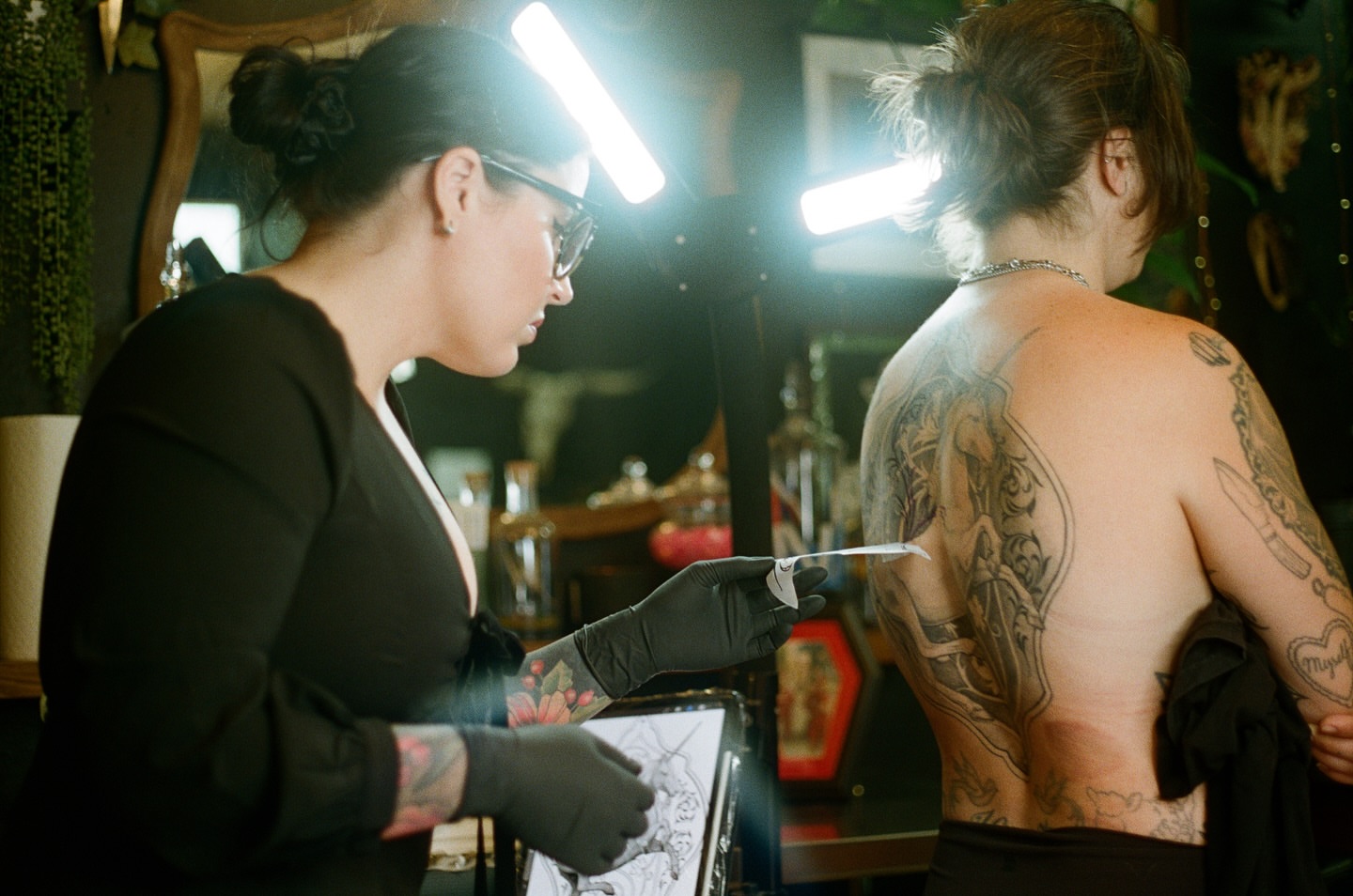 Knife and heart American traditional tattoo on the back by Emily Miller