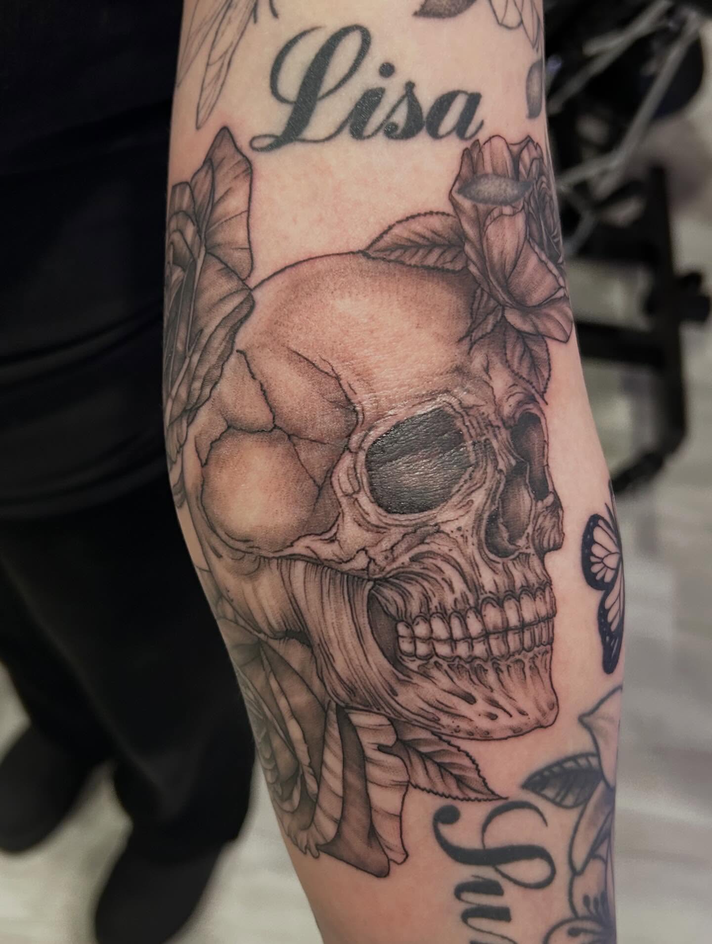 Skull with roses realism tattoo on the forearm by Jbtattoo Artistry